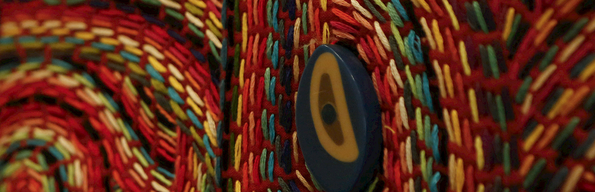 Close up detail photo of multi-colored fiber artwork.