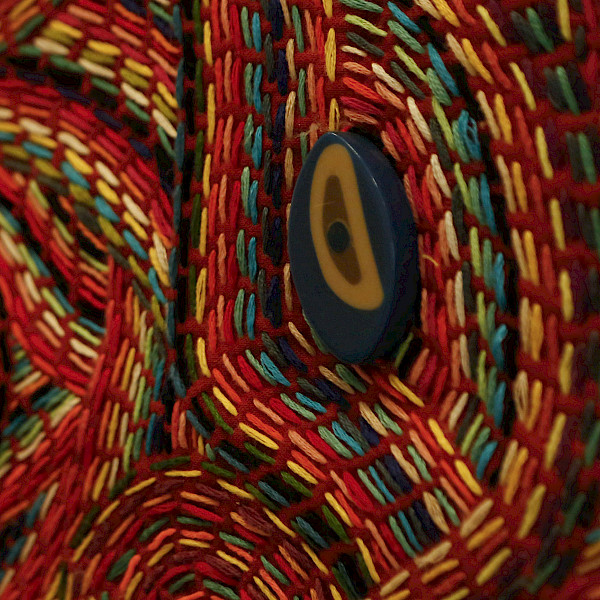 Close up detail photo of multi-colored fiber artwork.
