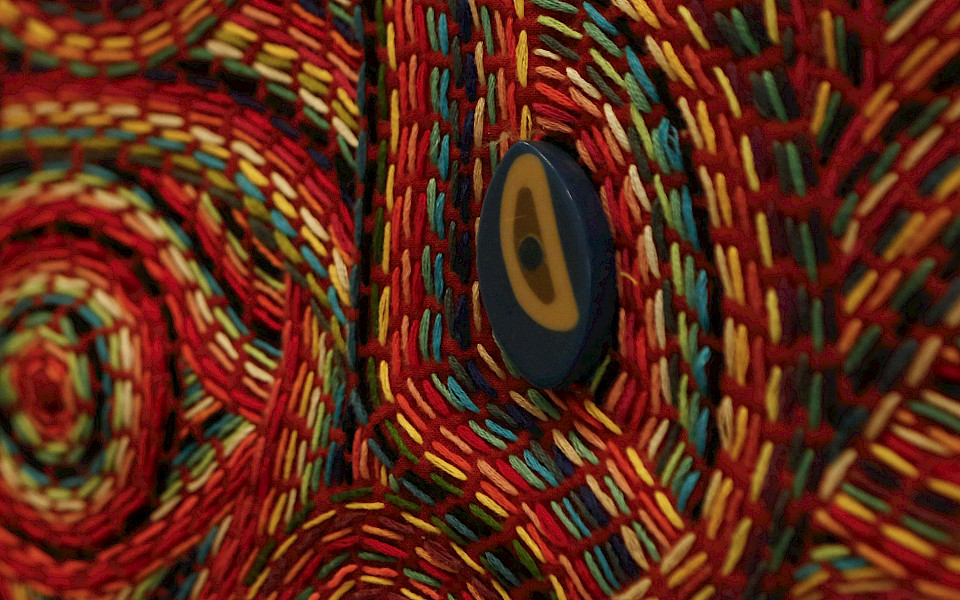 Close up detail photo of multi-colored fiber artwork.