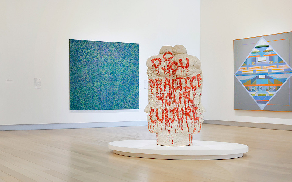Photo of a woman and a man looking at contemporary art in an art gallery.