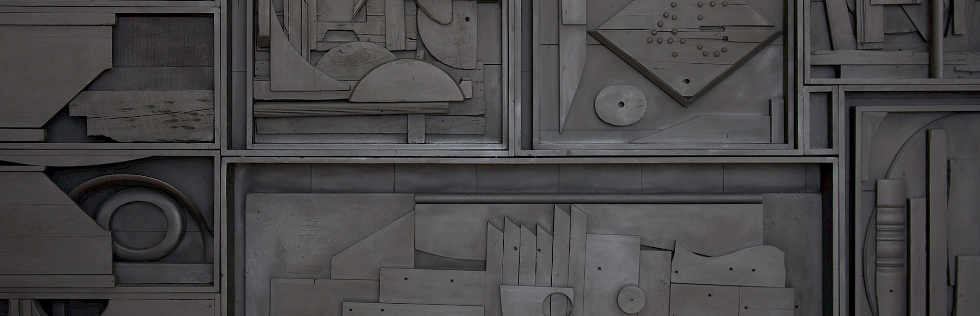 Photo of a black found object sculpture by Louise Nevelson.