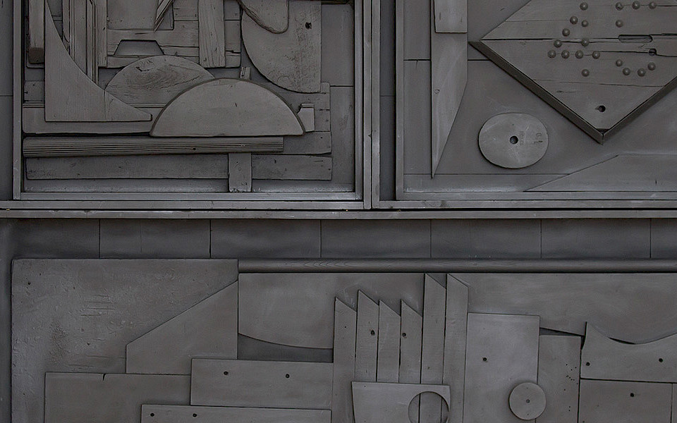 Photo of a black found object sculpture by Louise Nevelson.