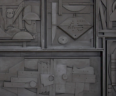 Photo of a black found object sculpture by Louise Nevelson.