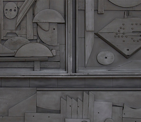 Detail photo of a black wooden sculpture by Louise Nevelson.