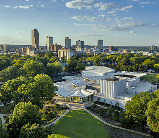 Aerial photo of the Arkansas Museum of Fine Arts with Downtown Little Rock visible in the background.