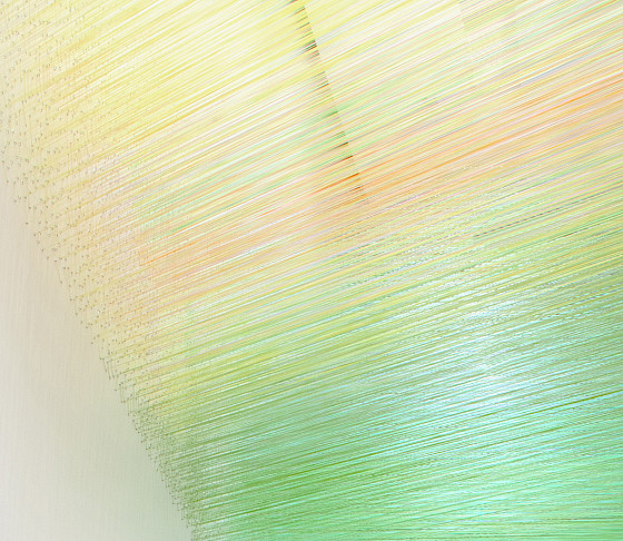Detail shot of an art installation of 3D flower boards in bright, abstract forms outlined in black with red, red, blue, yellow and white petals.